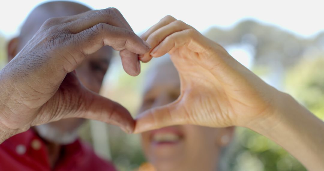 Senior Couple Creating Heart Shape with Hands - Free Images, Stock Photos and Pictures on Pikwizard.com