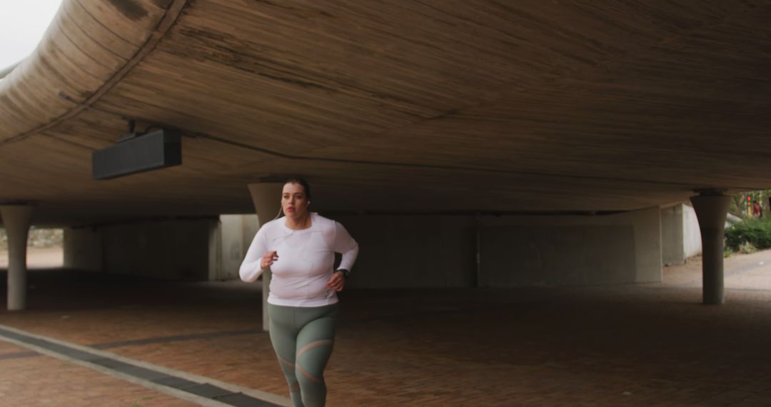 Woman Running Under Urban Bridge for Fitness and Workout - Free Images, Stock Photos and Pictures on Pikwizard.com