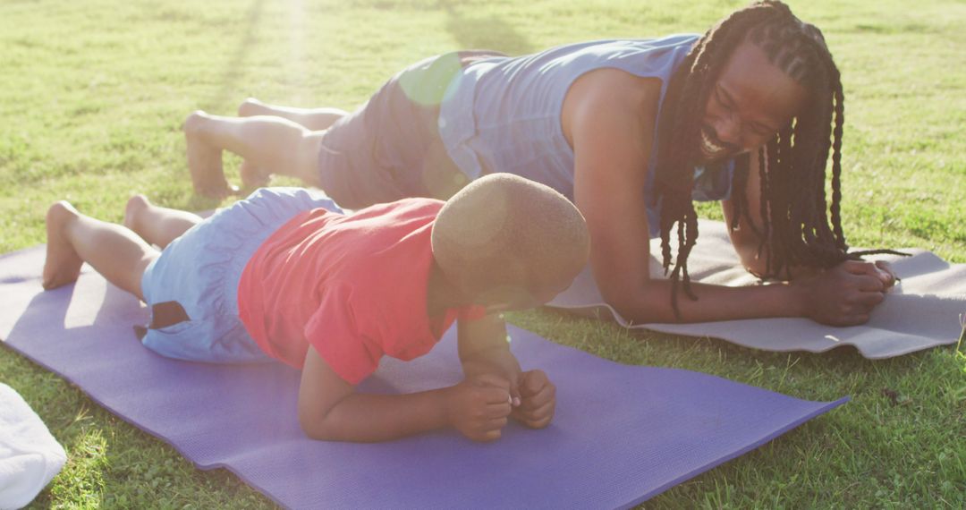 African American Mother and Son Planking Together Outdoors - Free Images, Stock Photos and Pictures on Pikwizard.com