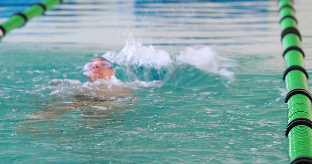 Swimmer Practicing Freestyle in Pool Lane - Free Images, Stock Photos and Pictures on Pikwizard.com