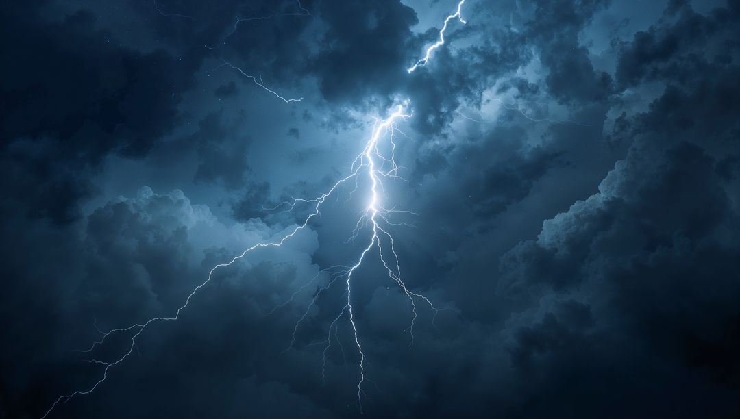 Dramatic Lightning Bolt Illuminates Storm Clouds in Night Sky