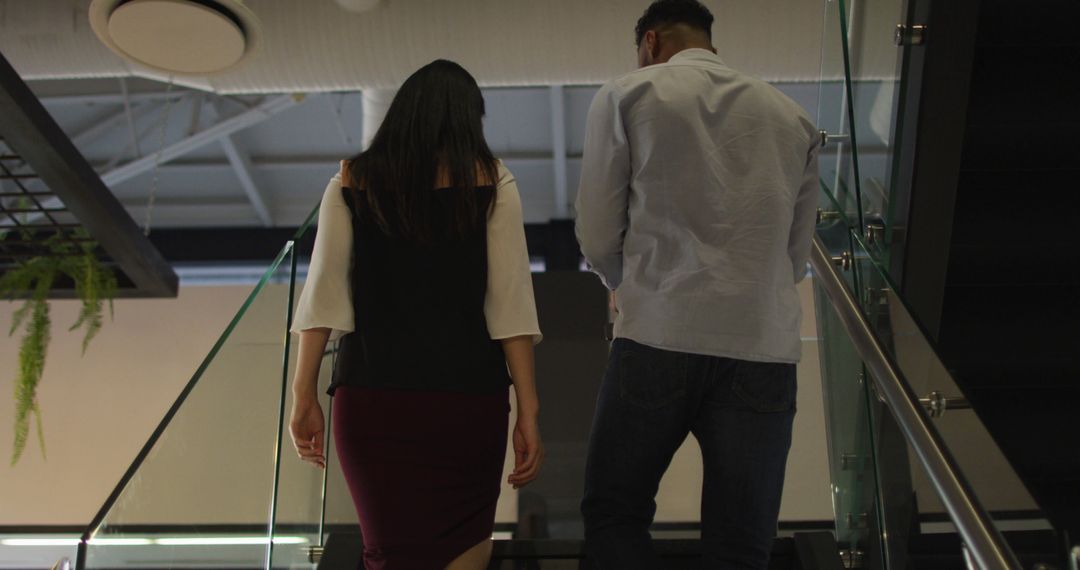 Colleagues Collaborating on Office Stairway During Evening Hours