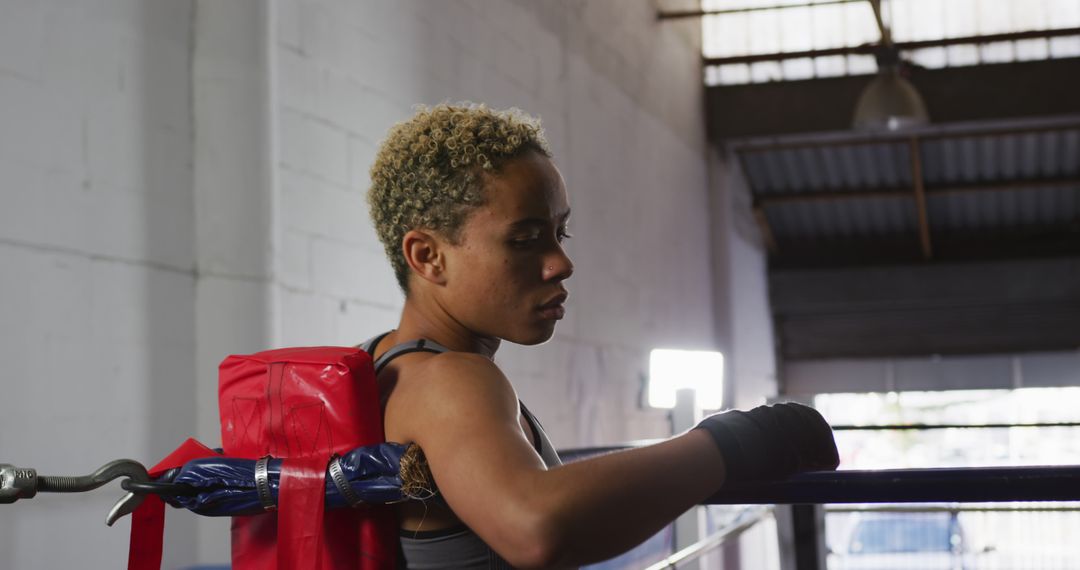 Female Boxer Resting on Boxing Ring Rope in Gym - Free Images, Stock Photos and Pictures on Pikwizard.com