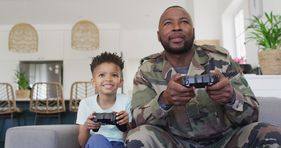 Father in Military Uniform Playing Video Games with Son at Home
