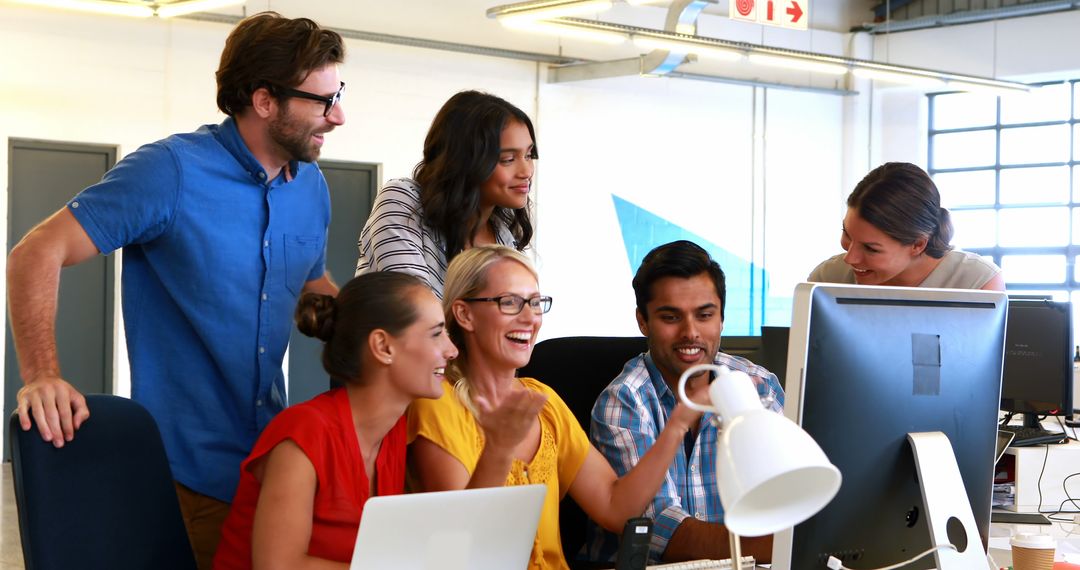 Team Collaborating in Modern Office Over Computer Screen