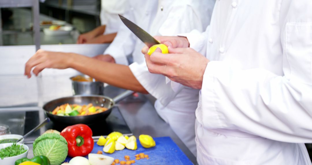 Cooks Preparing Vegetables in Professional Kitchen - Free Images, Stock Photos and Pictures on Pikwizard.com