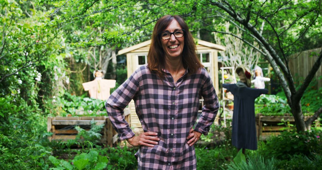 Woman Smiling in Garden with Wooden Shed and Scarecrows in Background - Free Images, Stock Photos and Pictures on Pikwizard.com