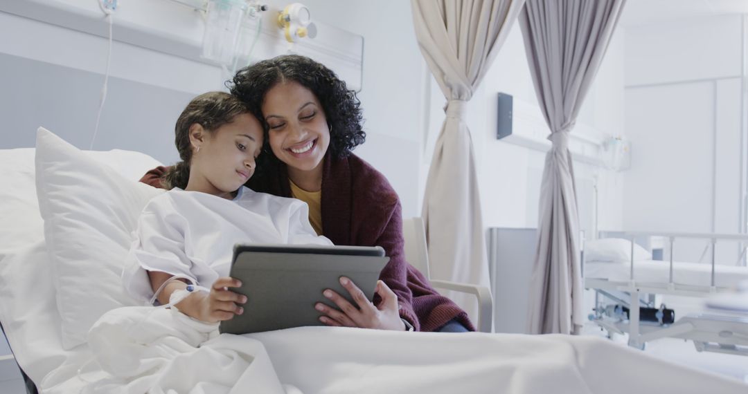 Mother and Daughter Using Tablet in Hospital Room - Free Images, Stock Photos and Pictures on Pikwizard.com