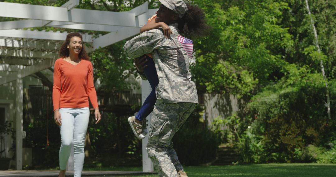 Returning Soldier Embracing Daughter by Outdoor Pathway