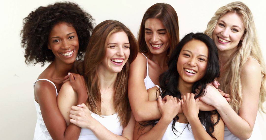 Diverse Group of Women Smiling and Hugging Each Other in White Shirts - Free Images, Stock Photos and Pictures on Pikwizard.com