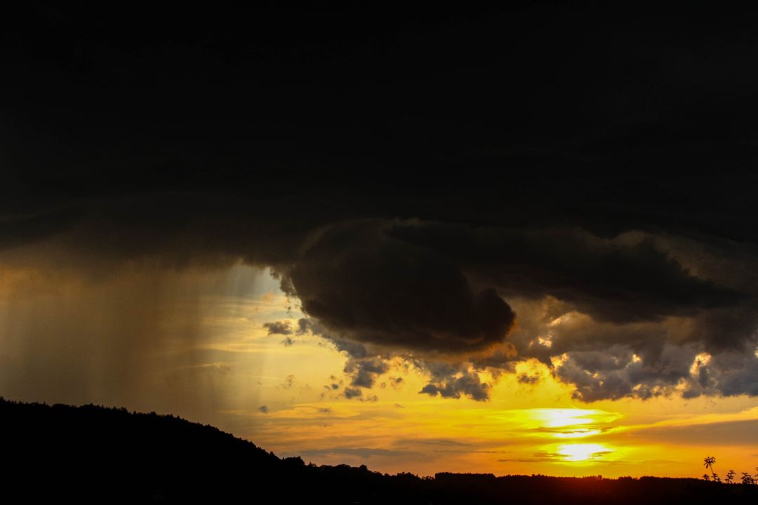 Dramatic Sunset with Dark Clouds and Heavy Rainfall - Free Images, Stock Photos and Pictures on Pikwizard.com