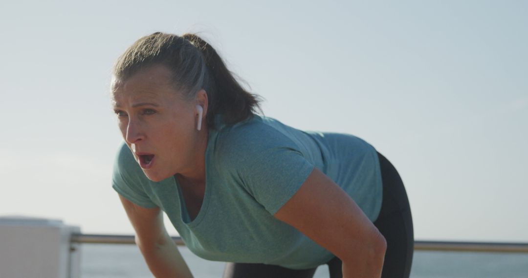 Woman Exercising Outdoors Wearing Wireless Earbuds - Free Images, Stock Photos and Pictures on Pikwizard.com