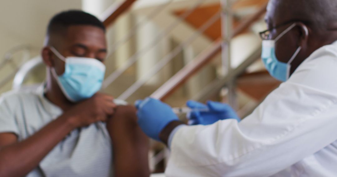 Healthcare Worker Vaccinating Patient Wearing Masks During Medical Appointment - Free Images, Stock Photos and Pictures on Pikwizard.com