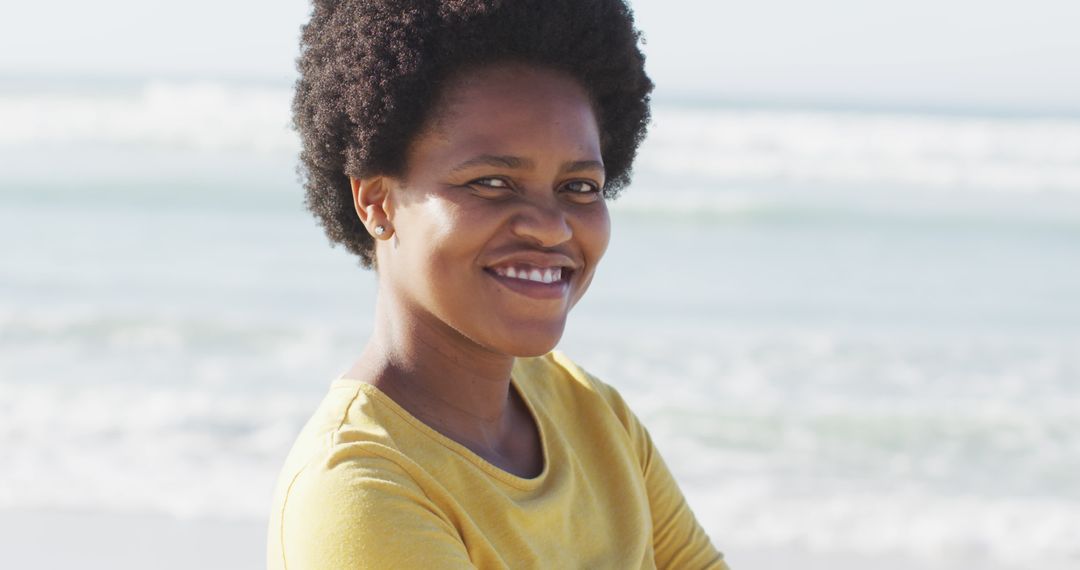 Portrait of happy african american woman on sunny beach - Free Images, Stock Photos and Pictures on Pikwizard.com