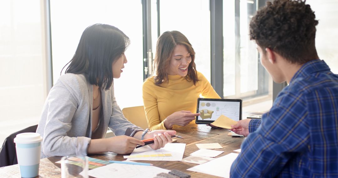 Creative Team Collaborating in Modern Office with Digital Tablet
