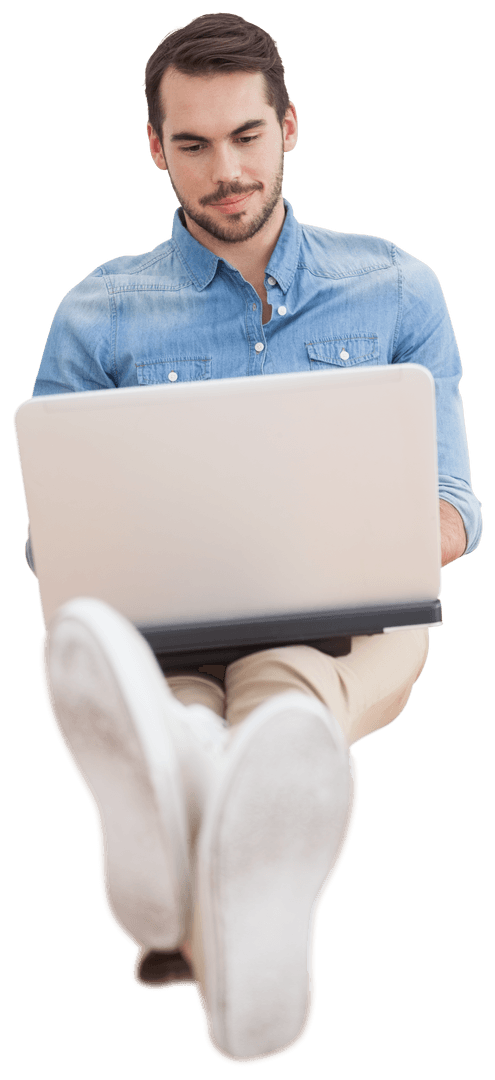 Casual Man in Denim Operating Laptop Transparent Background