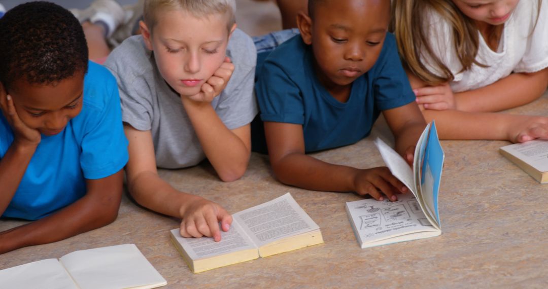 Children Reading Together on Floor Focusing on Books and Education