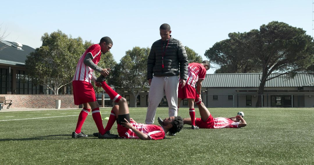 Youth Soccer Team Stretching on Field Before Practice Session