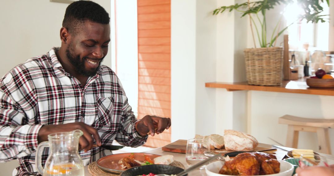Joyful Man Dining Casually at Home with Delicious Meal Spread