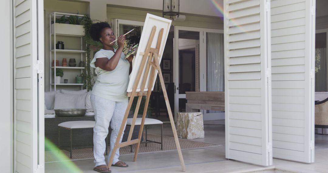 Woman Painting on Canvas in Home Studio with Open Doors - Free Images, Stock Photos and Pictures on Pikwizard.com