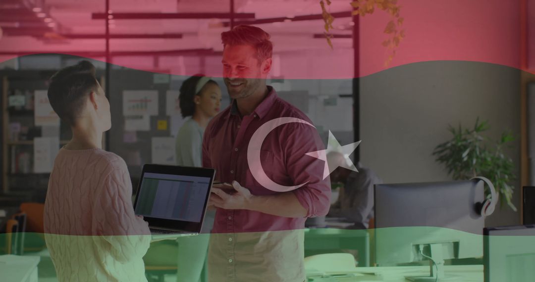 Coworkers Collaborating with Technology in Modern Office Environment