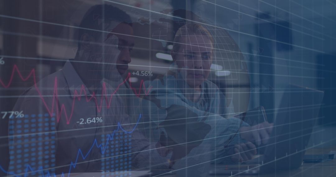 Colleagues Discussing Financial Data Overlayed with Graphs