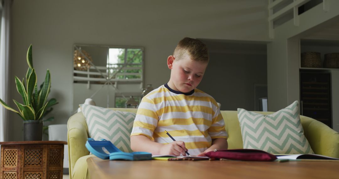 Child Doing Homework in Modern Living Room - Free Images, Stock Photos and Pictures on Pikwizard.com