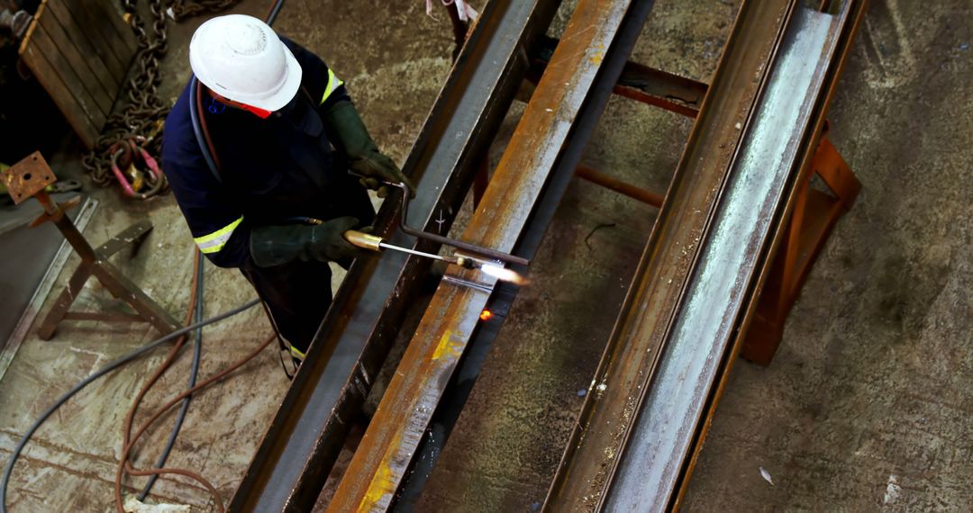 Welding Technician Working on Metal Beams in Industrial Workshop - Free Images, Stock Photos and Pictures on Pikwizard.com