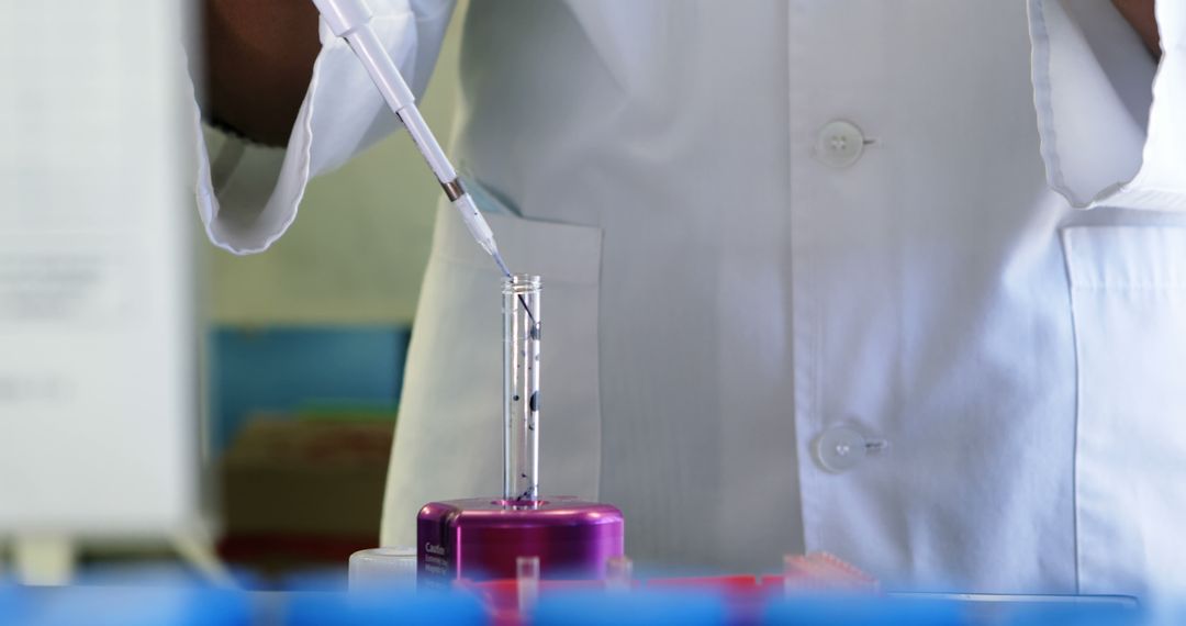 Scientist Performing Laboratory Test with Pipette and Test Tube - Free Images, Stock Photos and Pictures on Pikwizard.com