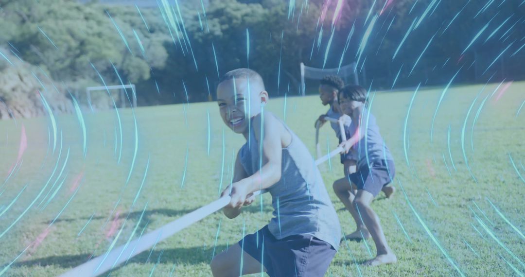 Children Playing Tug of War on Sunny Field with Energetic Overlay