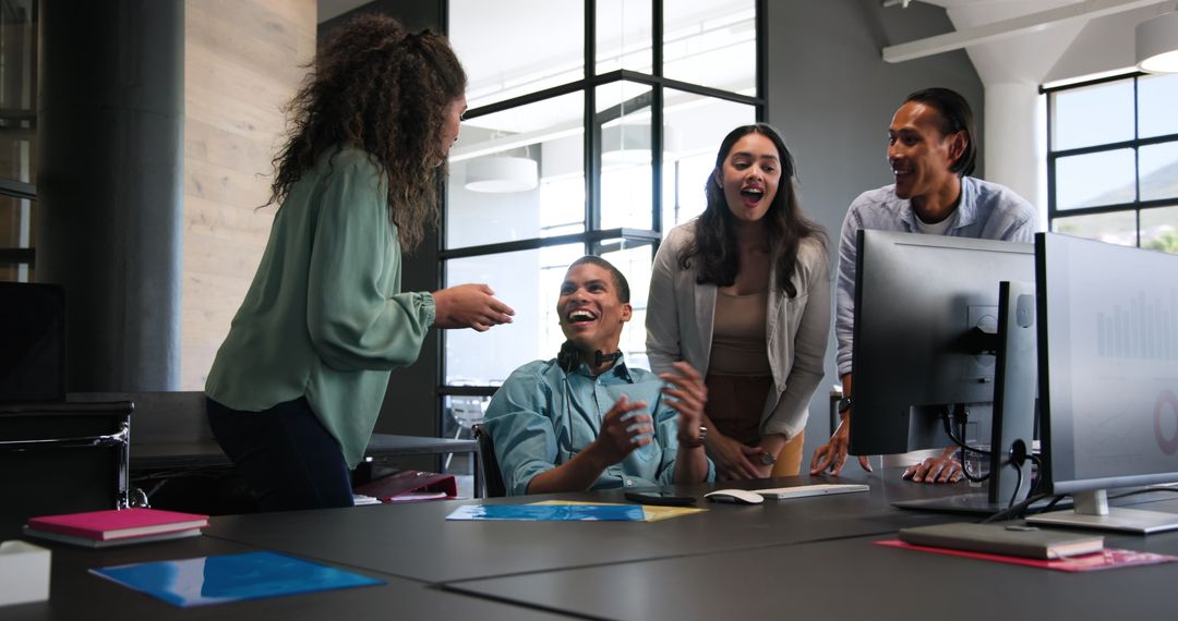 Diverse Team Celebrating Successful Project in Modern Office