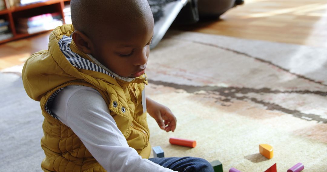 Young Boy Engaged in Play with Colorful Building Blocks at Home