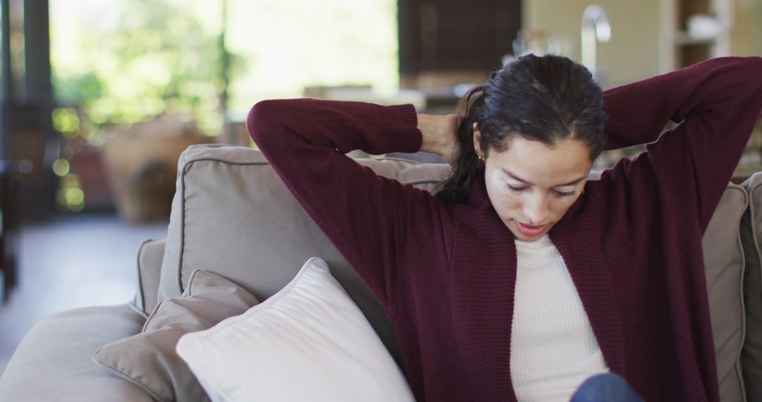 Woman Relaxing on Sofa at Home Enjoying Leisure Time