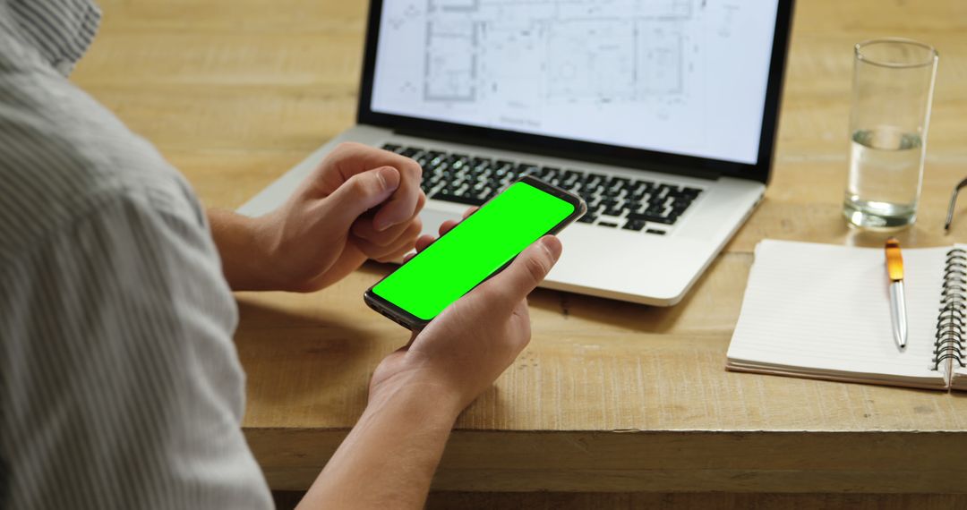 Person Using Smartphone with Green Screen in Home Office - Free Images, Stock Photos and Pictures on Pikwizard.com