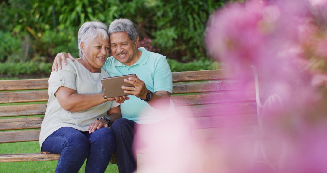 Image of happy biracial senior couple using tablet in garden - Free Images, Stock Photos and Pictures on Pikwizard.com