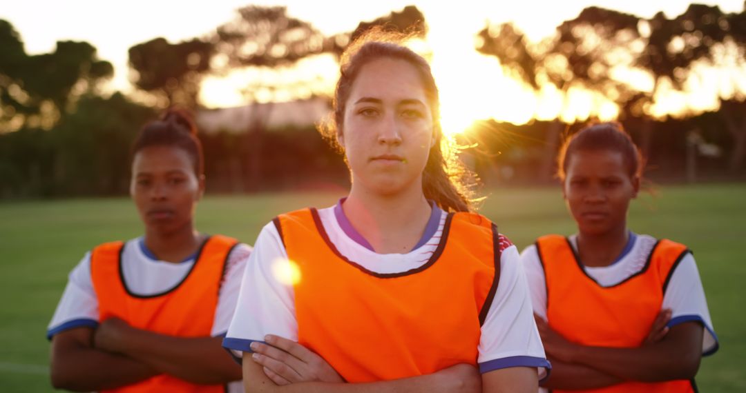 Determined Women's Soccer Team Posing at Sunset - Free Images, Stock Photos and Pictures on Pikwizard.com