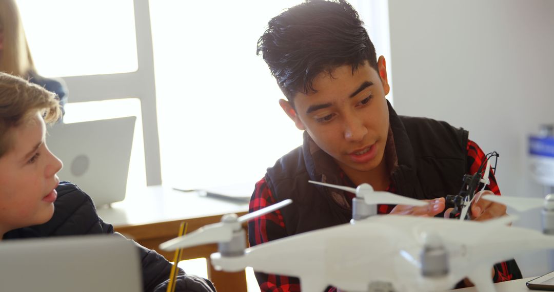 Two Teenagers Building and Testing Drone in Classroom Environment - Free Images, Stock Photos and Pictures on Pikwizard.com