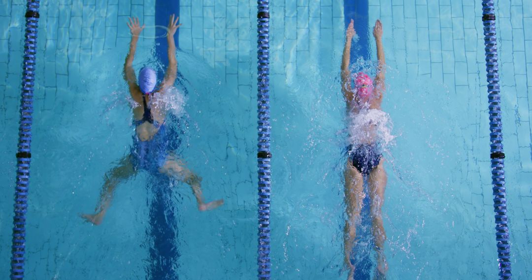 Competitive Swimmers Racing in Indoor Pool - Free Images, Stock Photos and Pictures on Pikwizard.com