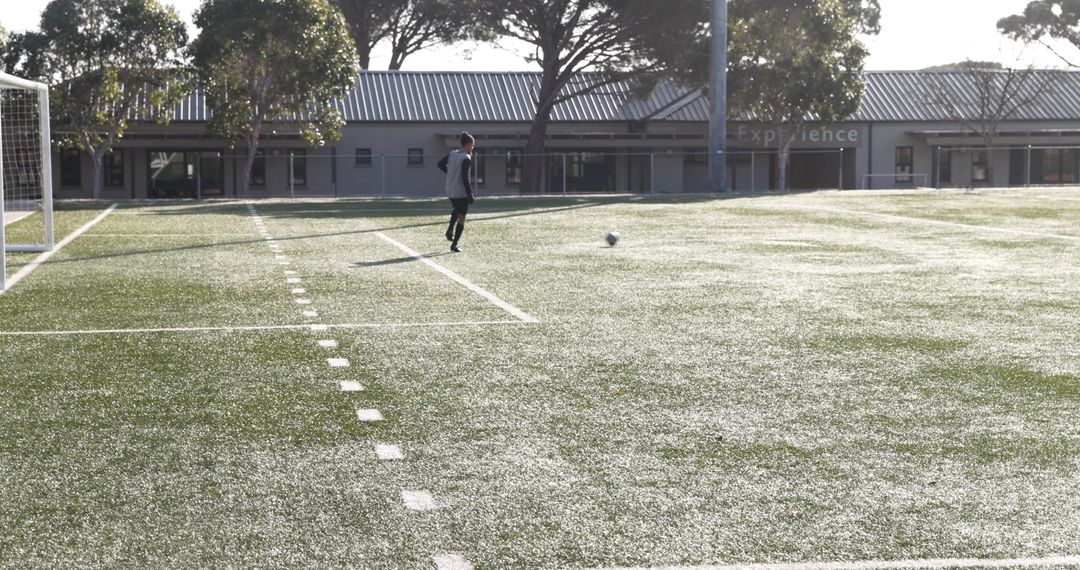 Soccer Player Practicing Skills on Sunny Field