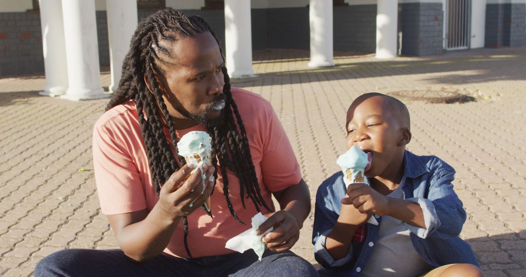 Father and Son Enjoying Ice Cream Outdoors - Free Images, Stock Photos and Pictures on Pikwizard.com