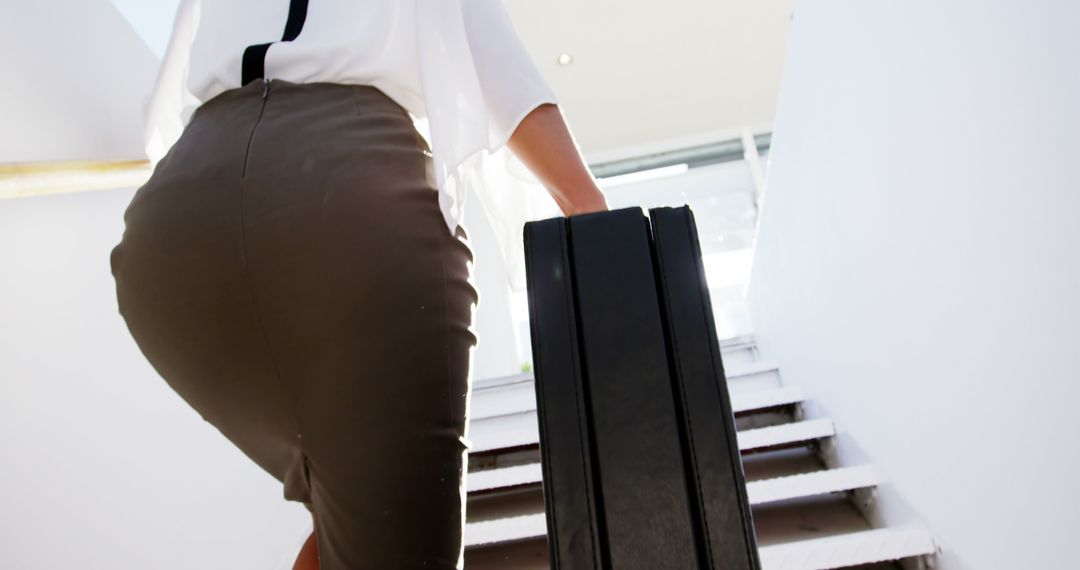 Businesswoman Ascending Stairs with Briefcase - Free Images, Stock Photos and Pictures on Pikwizard.com