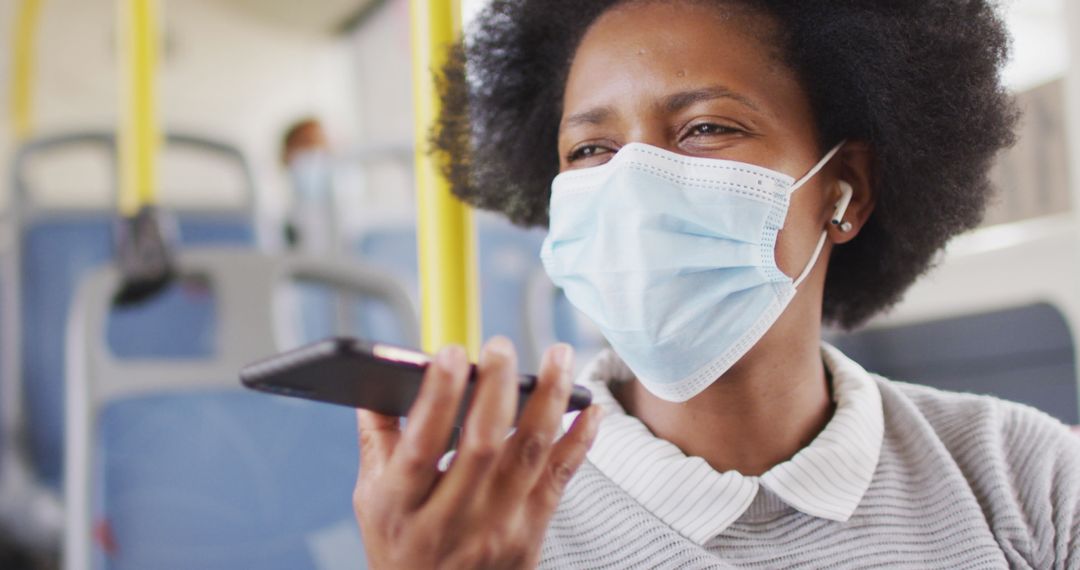 Woman with Mask Conversing on Smartphone on City Bus