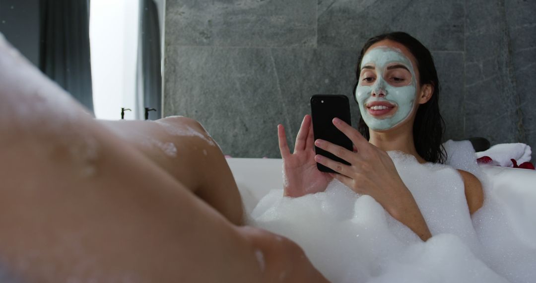 Woman Relaxing With Face Mask In Bathtub Using Phone - Free Images, Stock Photos and Pictures on Pikwizard.com