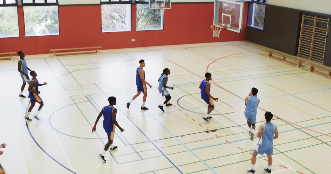 Diverse Basketball Team Playing Competitive Game in Gymnasium
