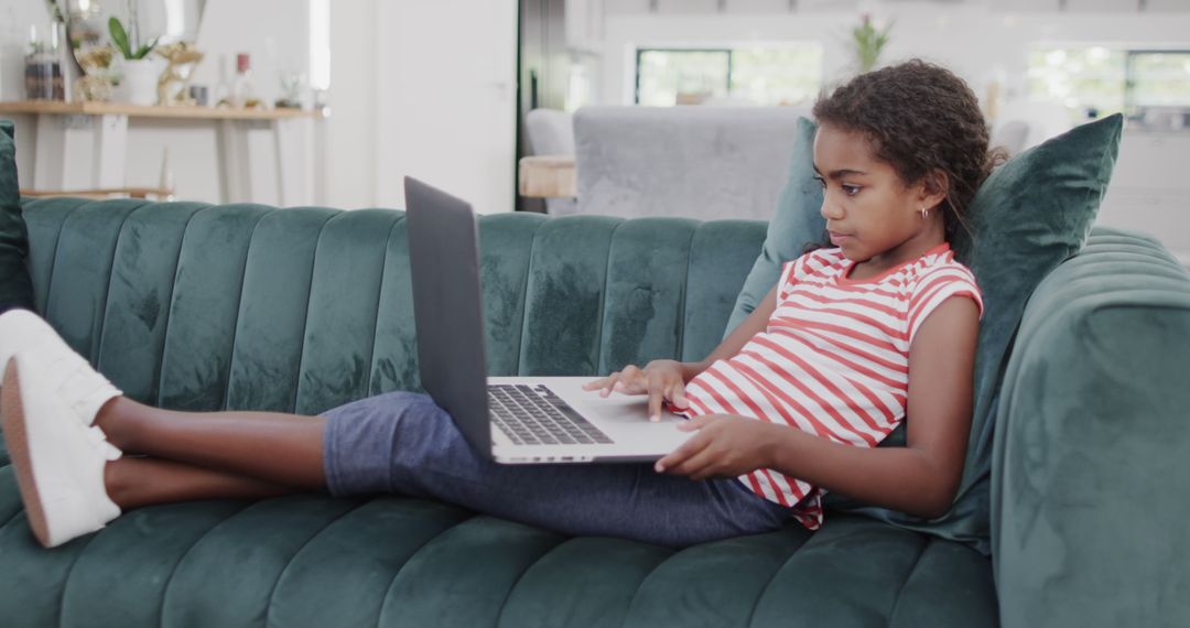 Curious African American Girl Doing Homework on Laptop at Home - Free Images, Stock Photos and Pictures on Pikwizard.com