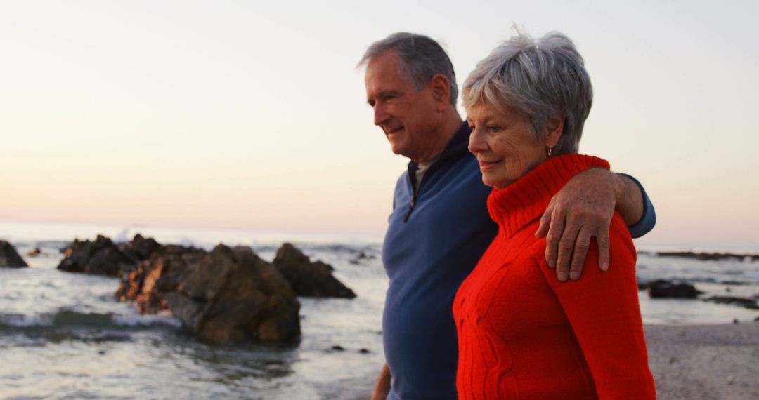 Senior Couple Walking on Rocky Beach During Sunset - Free Images, Stock Photos and Pictures on Pikwizard.com