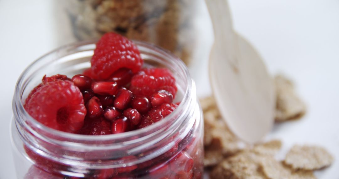 Healthy Breakfast Jar of Raspberries and Pomegranate Seeds - Free Images, Stock Photos and Pictures on Pikwizard.com