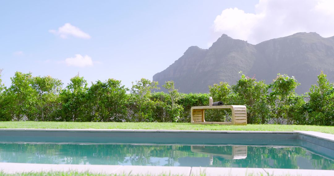 Tranquil Backyard Pool with Mountain View and Wooden Bench