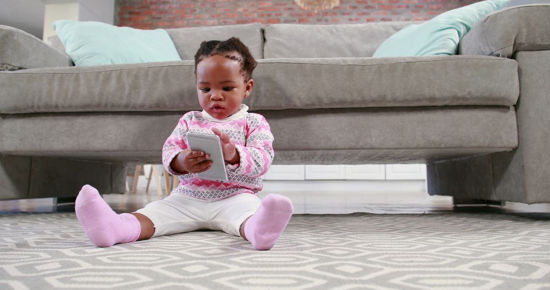 Cute Baby Girl Playing with Smartphone on Carpeted Floor - Free Images, Stock Photos and Pictures on Pikwizard.com