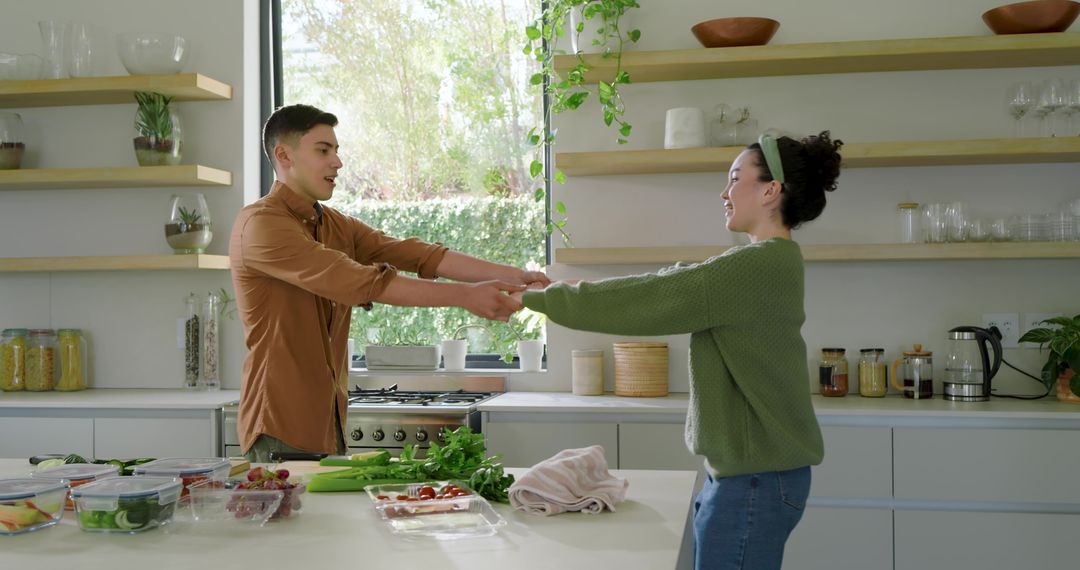 Joyful Couple Holding Hands in Modern Kitchen